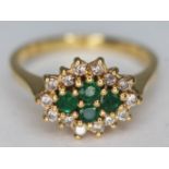 A hallmarked 18ct gold diamond and emerald cluster ring, gross wt. 4.25g, size P.