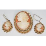 A yellow metal mounted cameo brooch and matching earrings, gross wt. 9.28g.