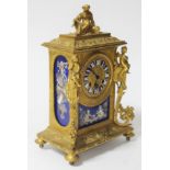 A late 19th century gilt metal clock with porcelain panels, height 26.5cm, later movement.