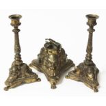 A gilt brass inkstand formed as three Greek theatrical masks, the lid formed as a tambourine