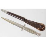 A Wilkinson Sword Fairbairn-Sykes commando knife and leather scabbard.