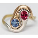 An entwined snake head ring set with a sapphire and a ruby, white metal setting and yellow metal