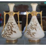 A pair of Royal Worcester blush ivory and gilt decorated vases, numbered 1021, height 24.5cm.