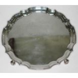 A silver salver with scallop edge and stood on four scroll feet, J.D. Chatterly and Sons, Birmingham