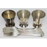A set of three Art Deco hallmarked silver shot glasses and a set of six hallmarked cake forks, wt.