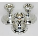 A set of three hallmarked silver candlesticks, height 6.5cm.