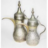 A matched pair of middle eastern white metal coffee pots, both marked 'G.Silver', height 26cm and