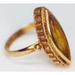 A continental ring set with a marquis cut citrine, marked '750', gross wt. 5.73g, size R.