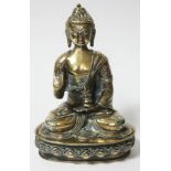 A Tibetan silver and copper overlaid bronze seated buddha, height 31cm.