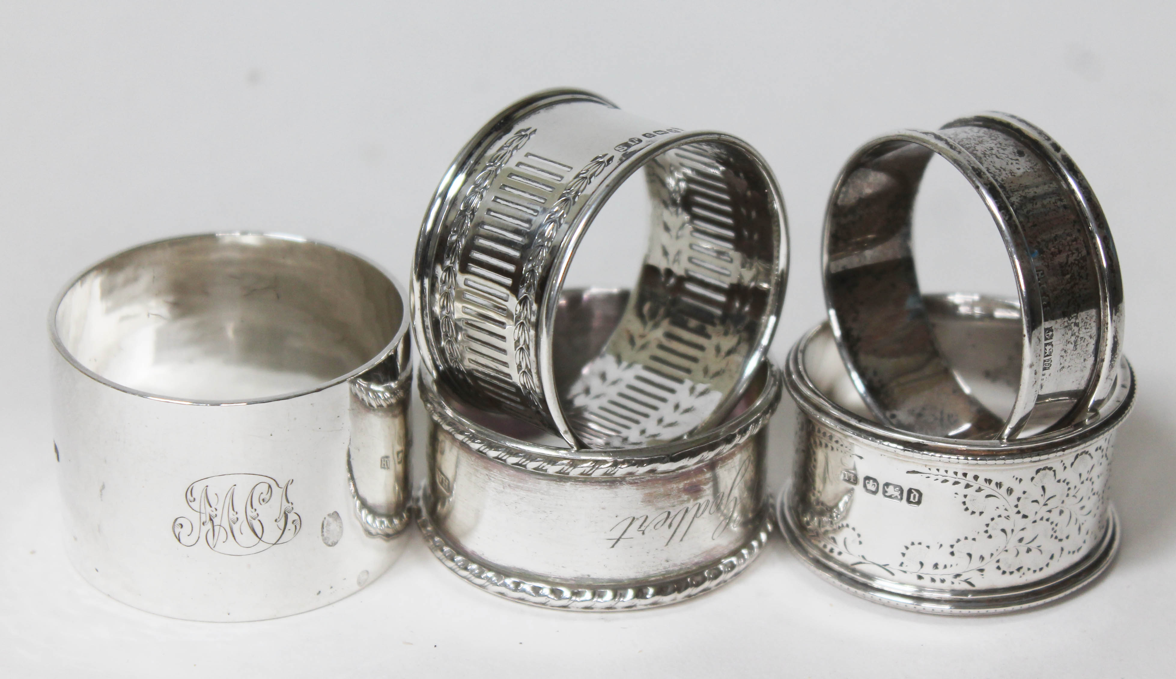 A group of five hallmarked silver serviette rings, wt. 5oz.