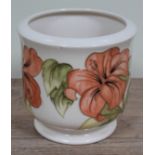 A Moorcroft pottery planter, Hibiscus on cream ground, height 17cm.