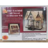 A boxed Orchid All Wood Dollhouse Kit.