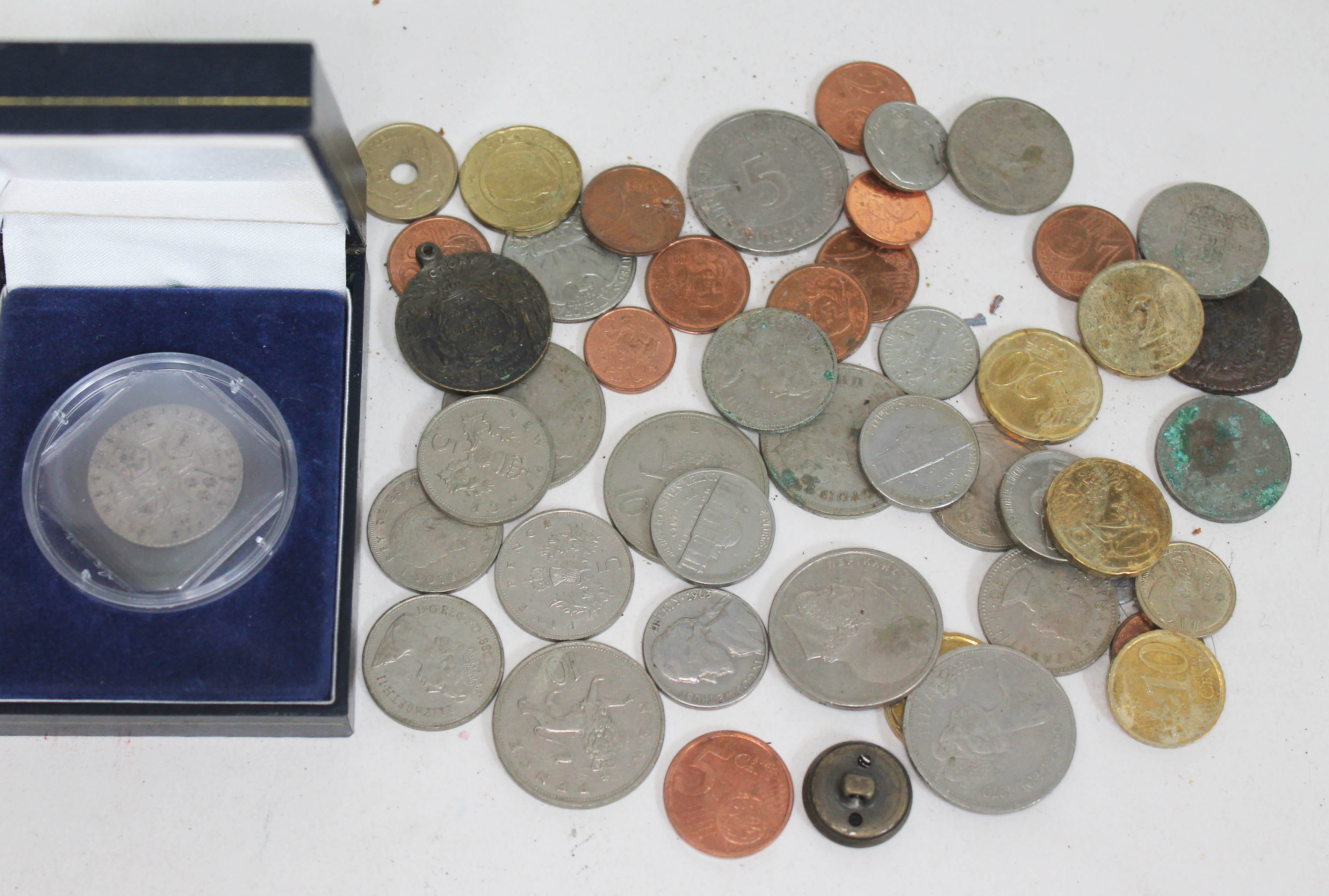 A box of coins including a George III 1787 florin, an Australian 1918 peace medallion etc.