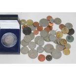 A box of coins including a George III 1787 florin, an Australian 1918 peace medallion etc.