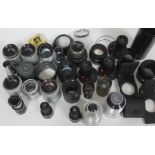A quantity of various camera lenses and accessories.