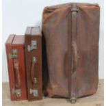 A vintage leather Gladstone type bag and two vintage leather cases.