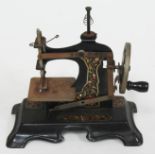 A child's hand crank toy sewing machine.