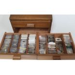 A wooden specimen cabinet containing mainly GB milled coins.