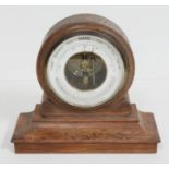 An oak framed aneroid barometer.