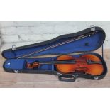 An early 20th century student violin, length of back 37.5cm, with hard case and bow.