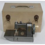 A child's vintage Vulcan sewing machine in wooden case.