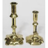 A matched pair of early 18th century brass pusher candlesticks, heights 17cm and 22cm.