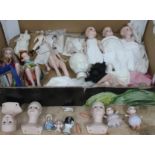 A box of mainly porcelain dolls, together with some additional porcelain pin cushion dolls etc.