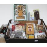 A box of dolls house furniture and accessories, many pieces in original packaging.