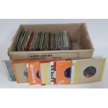 A box of 45s, over 100, including 1960s, easy listening, and world music