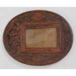 A carved Chinese photograph frame of oval form circa 1900, 21cm x 16cm.