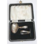 A cased hallmark silver christening set.