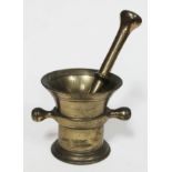 A brass mortar and pestle, height of mortar 10.5cm, length of pestle 21cm.