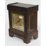 A German mantle clock circa 1900 with carved dentilated cornice and carved floral detail, the