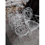 Four wrought metal garden chairs.