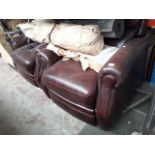 A pair of brown leather manual reclining armchairs.