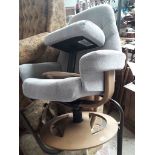 A grey swivel reclining armchair.