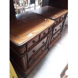 A pair of reproduction bedside chests of drawers.