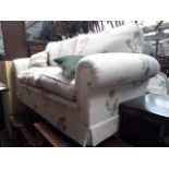 A Diane Rita chesterfield style settee with thistle pattern upholstery.