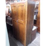 A 1930s fitted oak wardrobe.