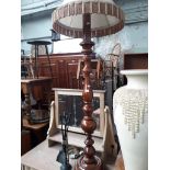 A stained wood standard lamp.