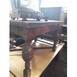 A 1920s drawer leaf oak refectory table with bulbous legs.
