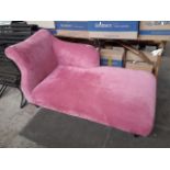 A modern pink chaise lounge.