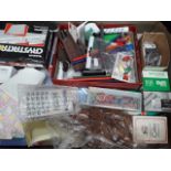 A box of small stationery items including paper clips, rubber bands, calculator, staples etc