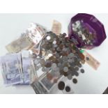 A plastic tub of misc world coins and bank notes