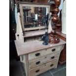 An Edwardian stripped wooden dressing table with Arts & Crafts style cut outs.