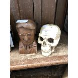 A wooden bust and a resin skull