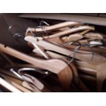 A large box of wooden coat hangers