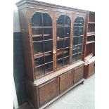 A reproduction walnut cabinet bookcase.