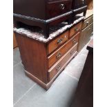 An Edwardian chest of drawers with marble top.