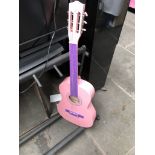 A pink Ready Ace childs acoustic guitar